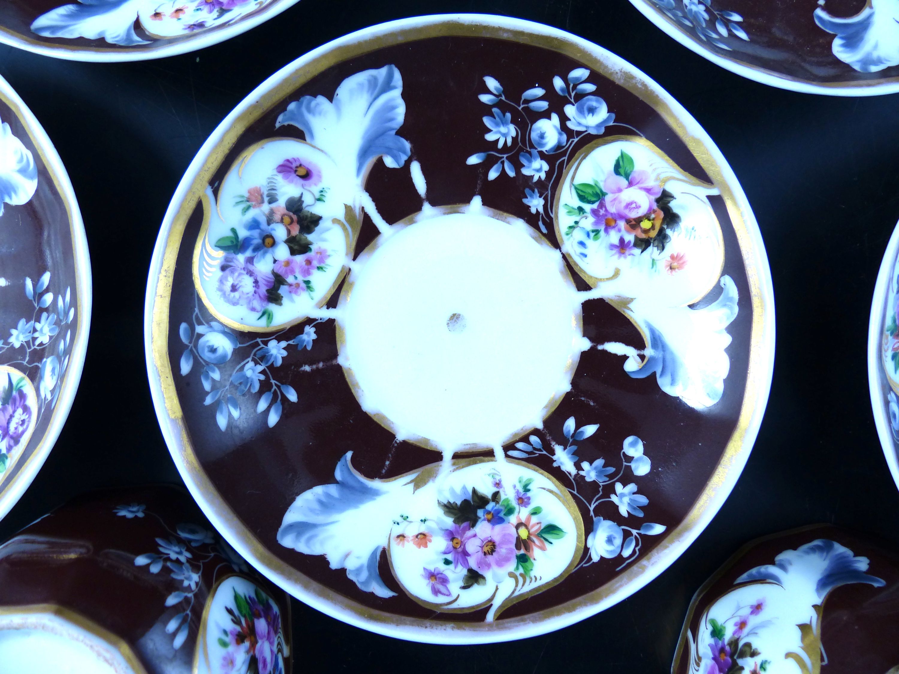 A set of seven Continental porcelain tea cups and saucers